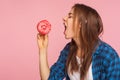 Profile of girl with crazy hungry expression craving doughnut, dreaming of biting sweet donut