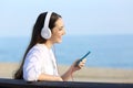 Profile of a girl listening to music on the beach Royalty Free Stock Photo