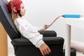 Profile of a girl sitting during a biofeedback session in a clinic