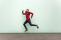 Profile happiness jumping man in red shirt with beard and mustache, casual style. Royalty Free Stock Photo