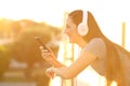 Profile of a happy girl listening music in a balcony Royalty Free Stock Photo