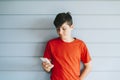 Profile of a happy male teen texting on a smart phone Royalty Free Stock Photo