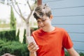 Profile of a happy male teen texting on a smart phone Royalty Free Stock Photo