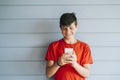 Profile of a happy male teen texting on a smart phone Royalty Free Stock Photo