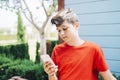 Profile of a happy male teen texting on a smart phone Royalty Free Stock Photo