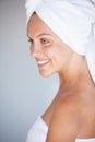 Profile of happy woman, thinking or towel for skincare or wellness in bathroom for glow or detox. Morning, clean or