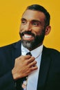 profile headshot of handsome positive smiling happy bearded man in suit with hand on tie, looking away at copy space Royalty Free Stock Photo