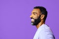 profile headshot of a handsome smiling african american man with beard and mustache purple shirt looking away at copy Royalty Free Stock Photo