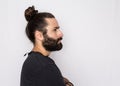 Profile of hipster beard man looking away with thoughtful expression. Standing against white background Royalty Free Stock Photo