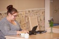 Profile image of overweight caucasian woman working in a cafe