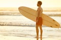 Profile of man holding a surfboard on the beach Royalty Free Stock Photo