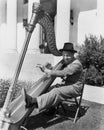 Profile of a man playing a harp and smiling