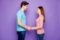 Profile photo of adorable guy lady couple standing opposite holding hands looking eyes love confession wear casual blue Royalty Free Stock Photo