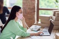 Profile photo of asian business lady manager organizing facial flu medical masks packs delivery boxes speaking landline Royalty Free Stock Photo