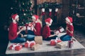 Profile photo of big family daddy mommy two children exchanging x-mas gifts sitting cozy floor near decorated garland Royalty Free Stock Photo