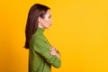 Profile photo of bossy lady hold arms crossed look side empty space wear casual sweater isolated yellow color background Royalty Free Stock Photo