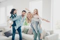 Profile photo of four family members having best leisure time pretend flight airplane indoors apartments