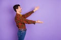 Profile photo of funny amazed guy stretch hands look empty space wear bow tie plaid shirt isolated violet background Royalty Free Stock Photo