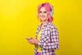 Profile photo of funny pink hairdo young lady hear music hold telephone wear plaid shirt isolated on yellow color