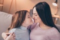 Profile photo of optimistic brunette red hairdo mom daughter hug sit on sofa wear sweater at home Royalty Free Stock Photo