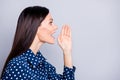 Profile photo of optimistic cute brunette girl tell secret wear blue blouse isolated on grey color background