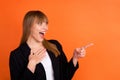 Profile photo of optimistic nice blond hair lady point empty space wear black jacket isolated on bright orange color