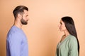 Profile photo of optimistic nice couple look each other wear sweater isolated on beige color background