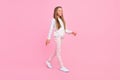 Profile photo of positive nice carefree small lady walk wear dotted shirt pants footwear pink color background