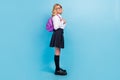 Profile photo of positive schoolgirl wear backpack white shirt stockings skirt shoes blue color background