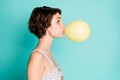 Profile photo of pretty lady big eyes holding big chewing gum inside mouth blowing large bubble wear casual white dotted Royalty Free Stock Photo