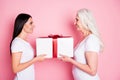 Profile photo of pretty old mother young daughter two ladies giving each other large gift box present affection feelings Royalty Free Stock Photo