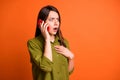 Profile photo of scared speechless lady hold telephone open mouth hand chest wear green shirt isolated orange color