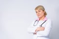 Profile photo of senior blonde family doc, patients consultation, friendly smiling, reliable, clinic virology, arms Royalty Free Stock Photo