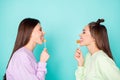 Profile photo of two funny cheerful ladies hold lollipop chupa chups hands childish mood tasty sweets wear green violet