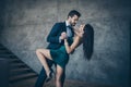 Profile photo of two stylish trendy people couple guy and lady slow dancing bending back holding hands bride and fiance Royalty Free Stock Photo