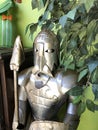 profile pic of shiny metal knight with sword, under tree leaves Royalty Free Stock Photo