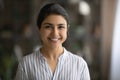 Indoor headshot portrait of cheerful young indian female businesswoman student