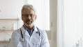 Profile picture of elderly male doctor in white medical uniform