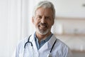 Profile picture of mature male doctor posing at workplace