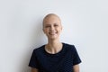 Headshot portrait of smiling hairless woman struggle with oncology