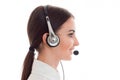 Profile portrait of attractive brunette call center worker girl with headphones and microphone isolated on white Royalty Free Stock Photo