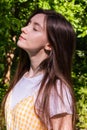 Profile Portrait Of A Beautiful Brunette Girl In A Park On A Hot Summer Sunny Day With Deep Shadows