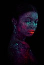 Profile portrait of a beautiful girl alien. Ultraviolet body art blue night sky with stars and pink jellyfish Royalty Free Stock Photo