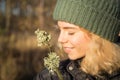 Profile portrait of a beautiful smiling teenager girl of 17 years old in a knitted green hat Royalty Free Stock Photo