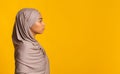 Profile portrait of black muslim woman in hijab over yellow background Royalty Free Stock Photo