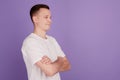 Profile portrait of cheerful confident guy crossed arms look empty space on violet background Royalty Free Stock Photo