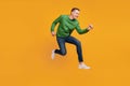 Profile portrait of energetic athletic guy jump run rush shopping season on yellow background