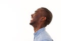 Profile portrait of handsome young black man laughing against isolated white background Royalty Free Stock Photo