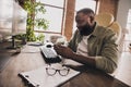 Profile portrait of happy hacker sit chair use telephone chatting texting workstation indoors Royalty Free Stock Photo