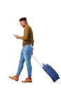 Happy young african american travel man walking with mobile phone and suitcase against isolated white background Royalty Free Stock Photo